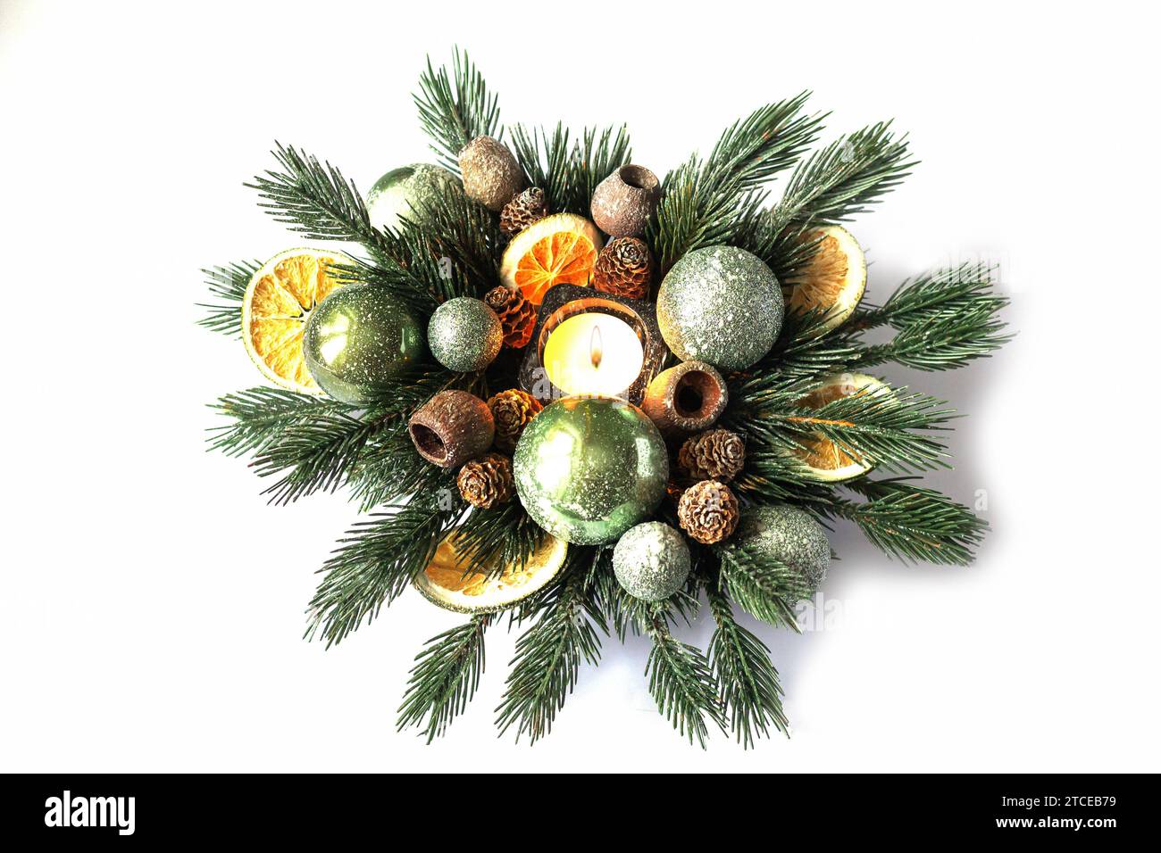 Christmas holidays composition with candle, spruce branches and decorations isolated on white background Stock Photo