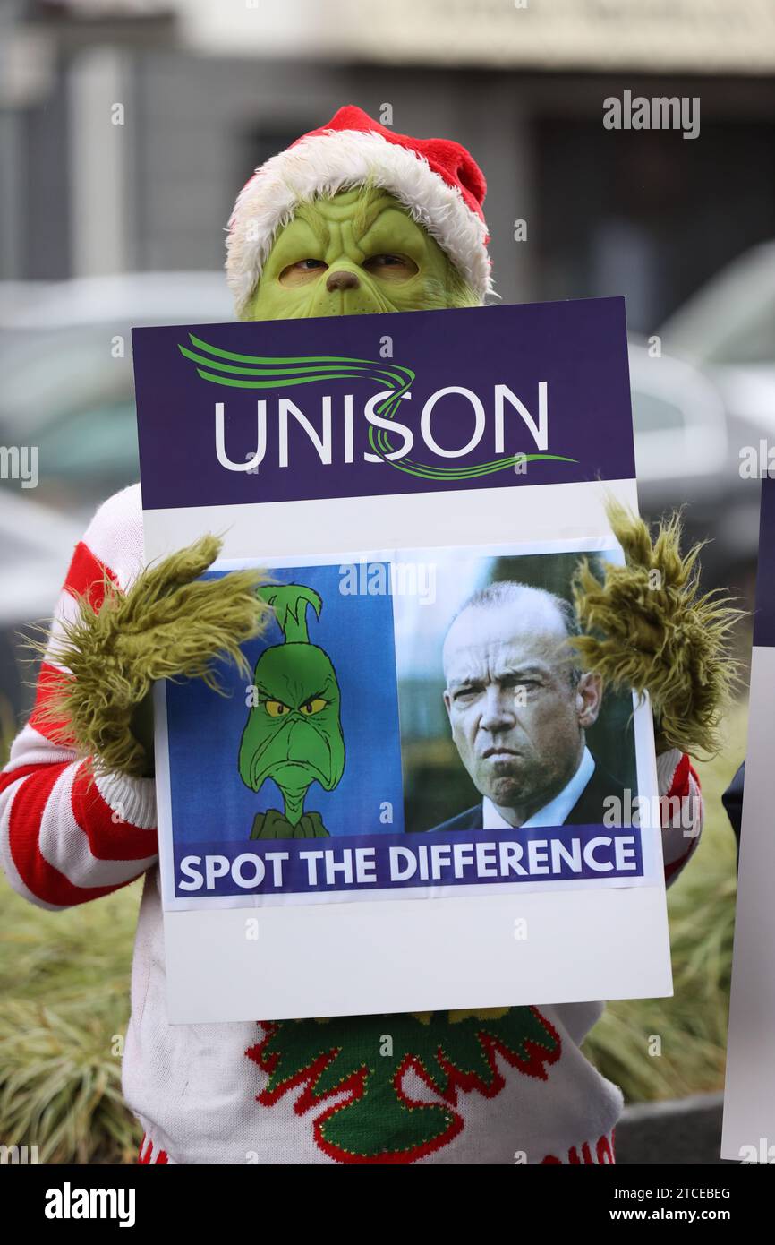 https://c8.alamy.com/comp/2TCEBEG/a-person-dressed-as-the-grinch-as-unison-health-workers-deliver-a-message-from-thousands-of-members-who-have-not-received-a-pay-rise-to-the-secretary-of-state-chris-heaton-harris-outside-erskine-house-belfast-picture-date-tuesday-december-12-2023-2TCEBEG.jpg