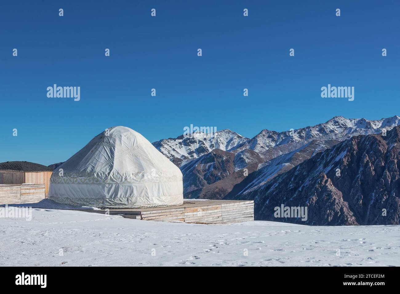 National house of the peoples of and Asian countries. Yurts on the background of snow peaks mountains and highlands. Yurt camp for tourists Stock Photo