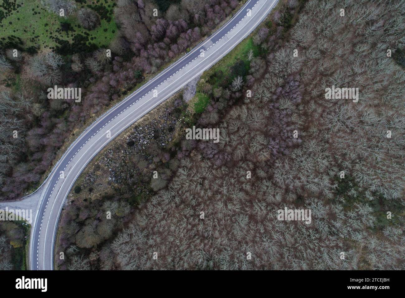 aerial view of a winding road on a wooded mountainside in winter Stock ...
