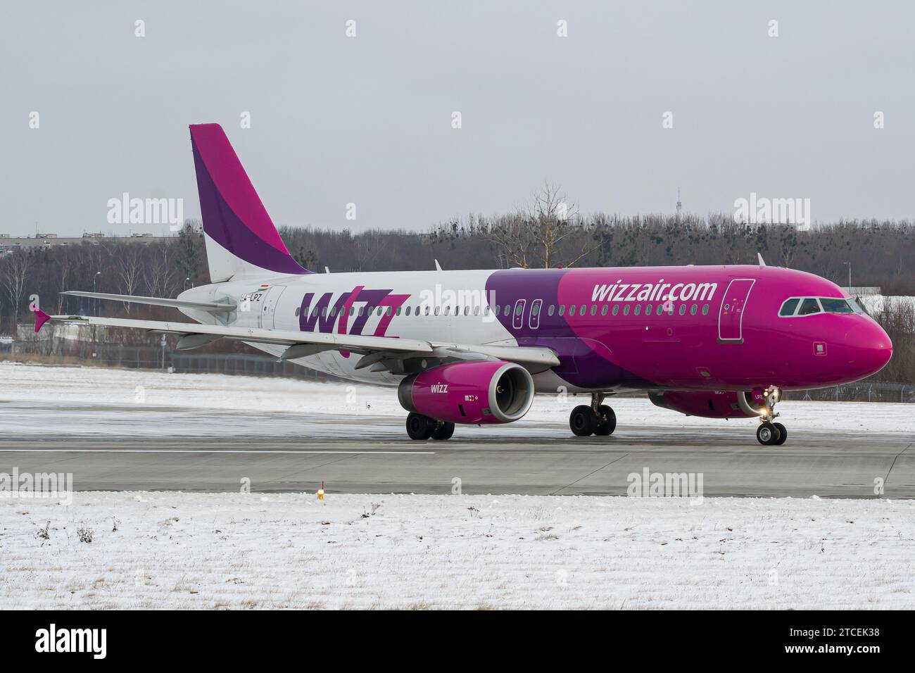 Hungarian low-cost airline's WizzAir Airbus A320 taxiing for takeoff from snowy Lviv Stock Photo
