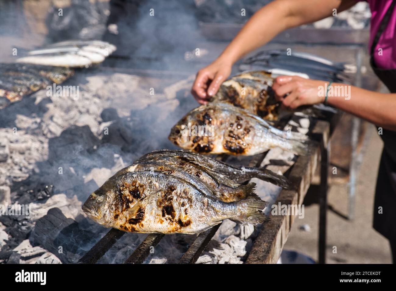 Fish roaster at a village festival in Sardinia Stock Photo - Alamy