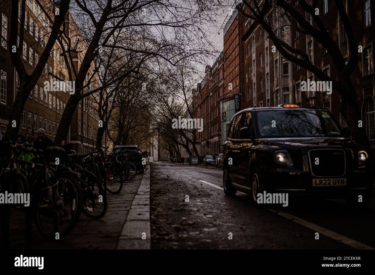 A dynamic winter cityscape showcasing the continuous movement of cabs, cars, trees, and buildings. The bustling energy captures the essence of London Stock Photo