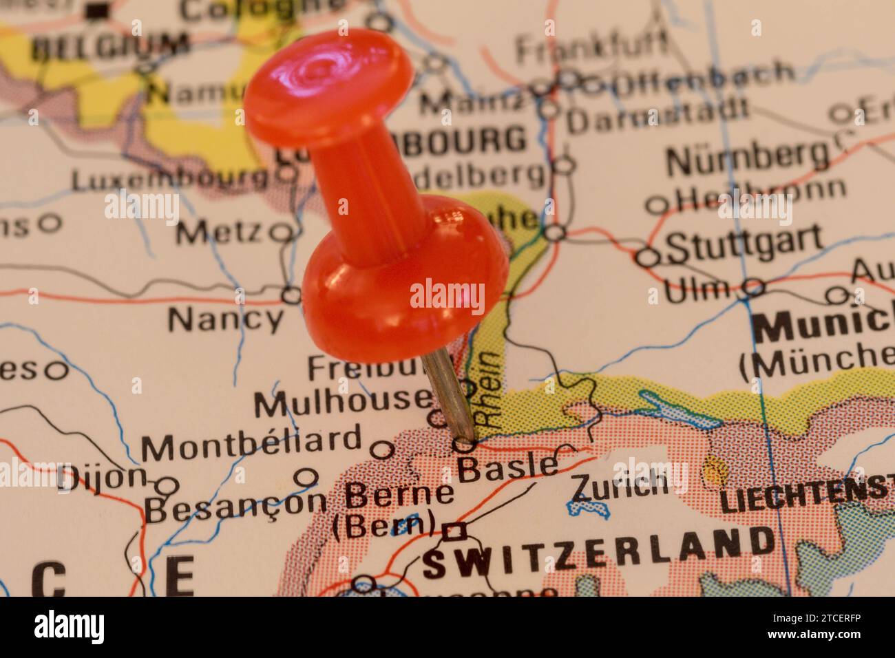 A red pin stuck into a map of Western Europe, pinpointing the location ...
