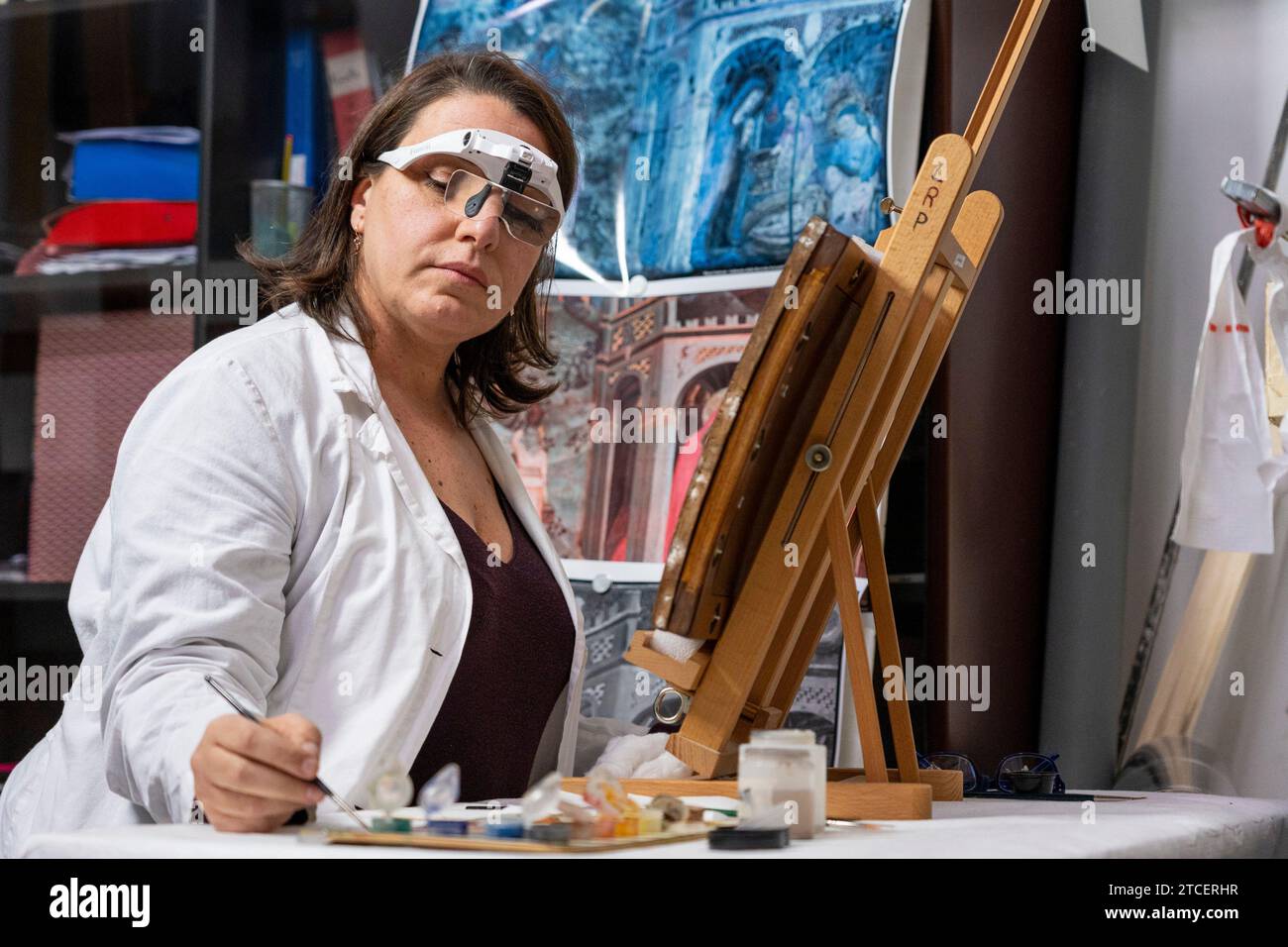 Vatican City, Vatican. 11th Dec, 2023. Restorer Chiara Notarstefano works on a painting at the 'Painting and Wood Materials Restoration Laboratory' inside the Vatican Museums. 'Beyond the surface: the restorer's gaze' is the title of the exhibition initiative with which the Vatican Museums celebrate the centenary of the foundation of the 'Painting and Wooden Materials Restoration Laboratory'. (Photo by Stefano Costantino/SOPA Images/Sipa USA) Credit: Sipa USA/Alamy Live News Stock Photo