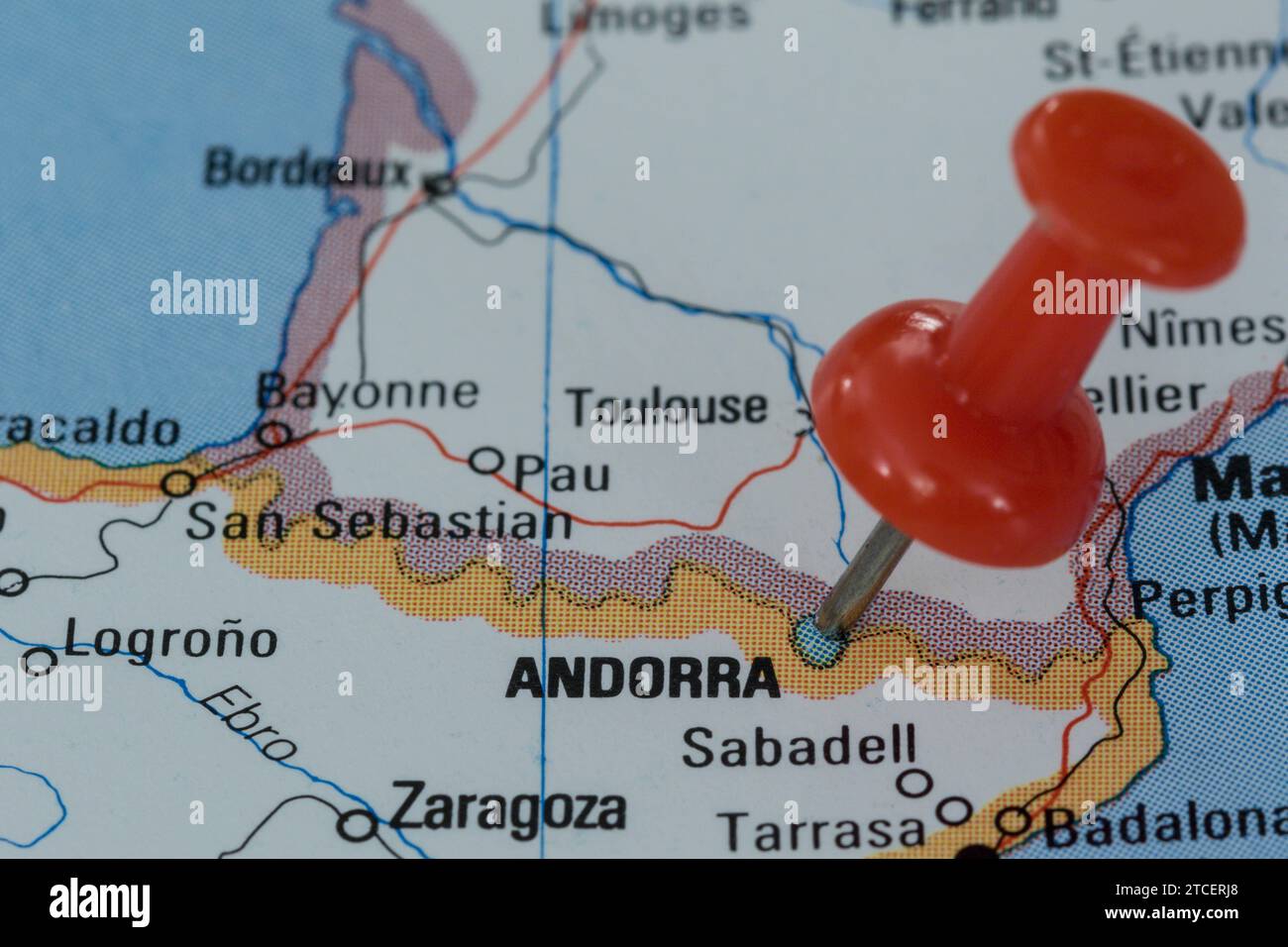 A red pin stuck into a map of Western Europe, pinpointing the location of Andorra Stock Photo