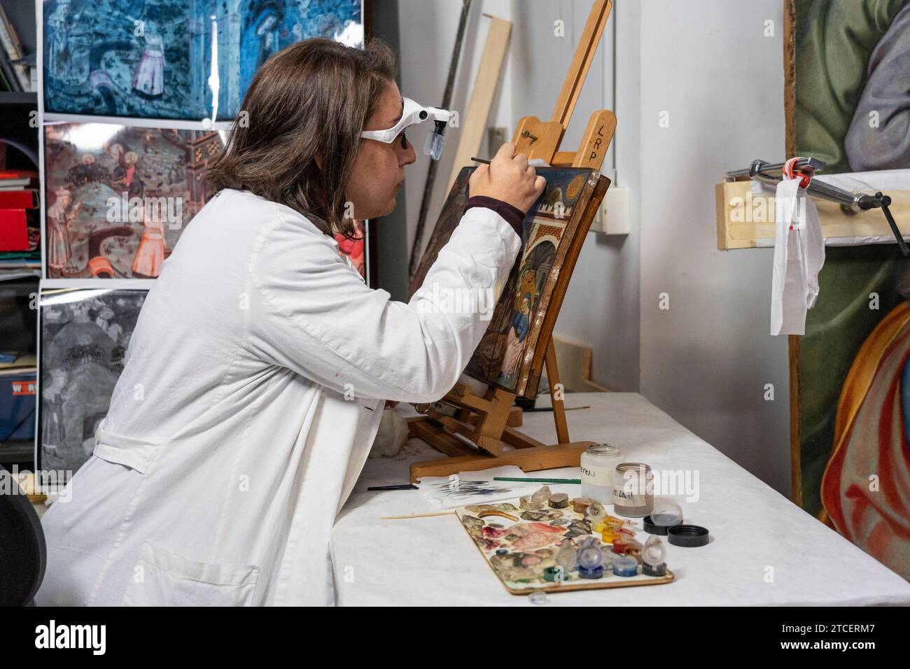 Vatican City, Vatican. 11th Dec, 2023. Restorer Chiara Notarstefano works on a painting at the 'Painting and Wood Materials Restoration Laboratory' inside the Vatican Museums. 'Beyond the surface: the restorer's gaze' is the title of the exhibition initiative with which the Vatican Museums celebrate the centenary of the foundation of the 'Painting and Wooden Materials Restoration Laboratory'. (Photo by Stefano Costantino/SOPA Images/Sipa USA) Credit: Sipa USA/Alamy Live News Stock Photo