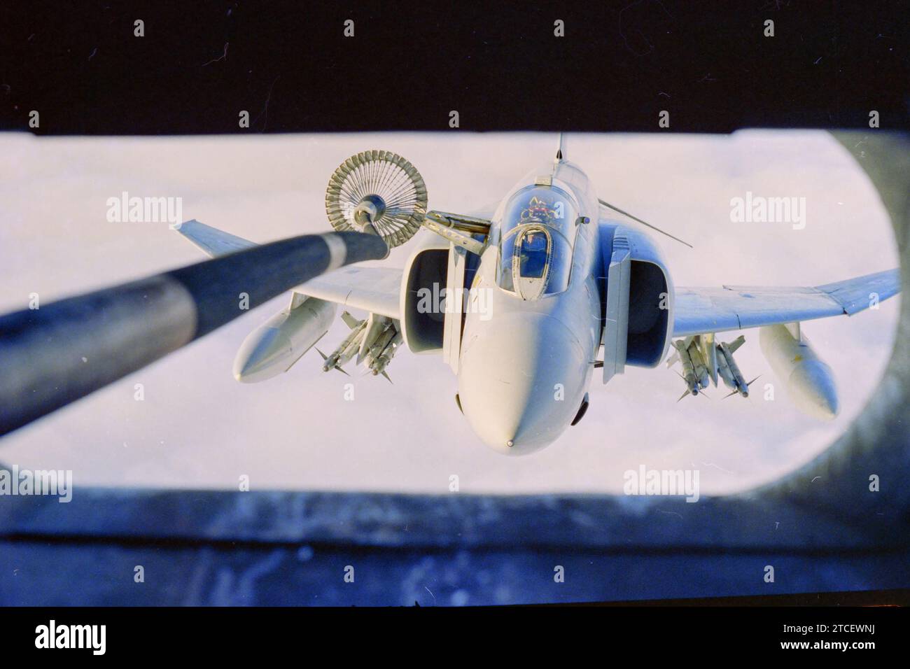 Archival slide scan. Royal Air Force McDonnell Douglas Phantom FGR2 fighter jet, during air to air re-fuelling from a C130 Hercules tanker. 1989 Falkland Islands. Stock Photo
