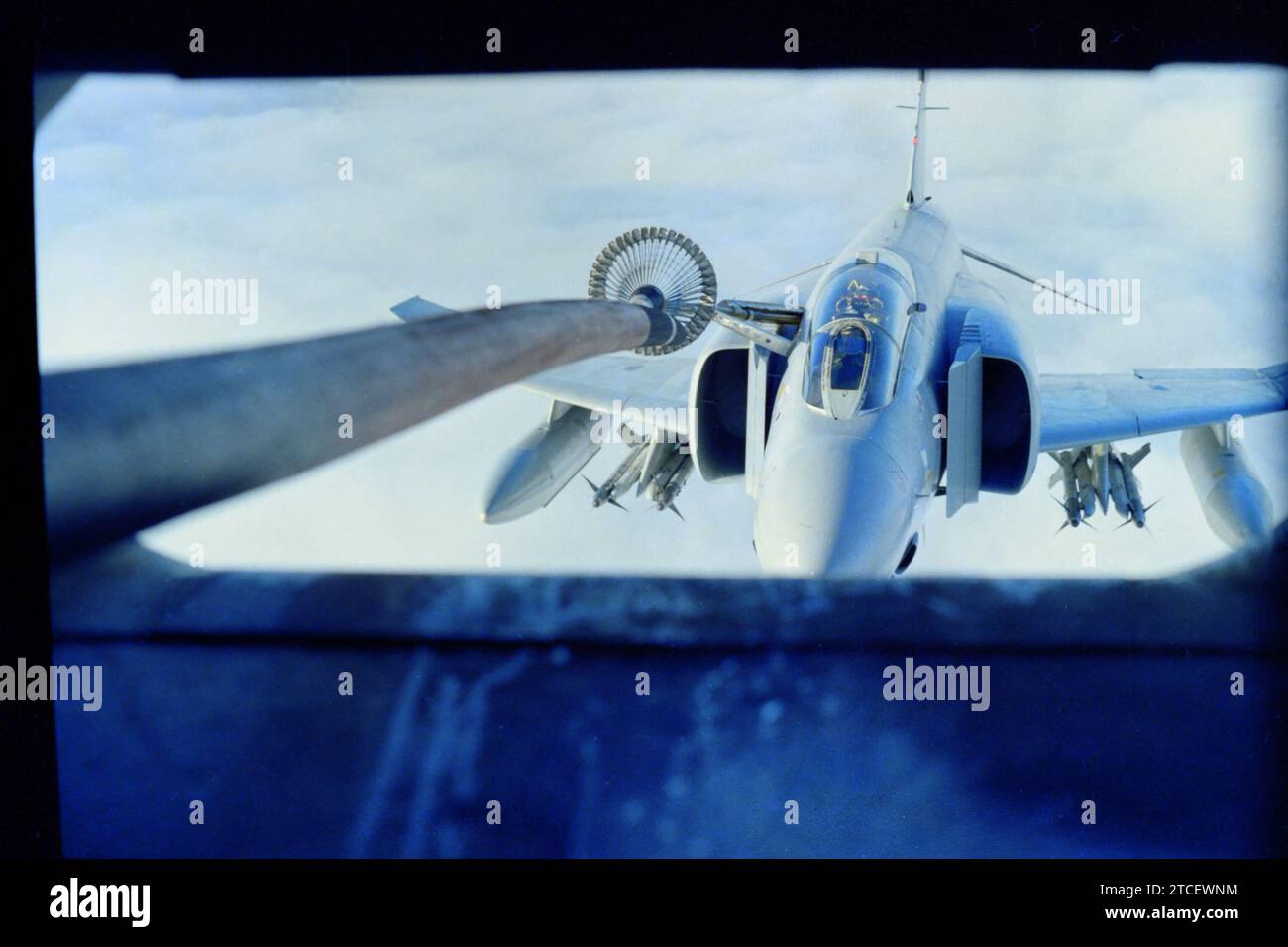 Archival slide scan. Royal Air Force McDonnell Douglas Phantom FGR2 fighter jet, during air to air re-fuelling from a C130 Hercules tanker. 1989 Falkland Islands. Stock Photo