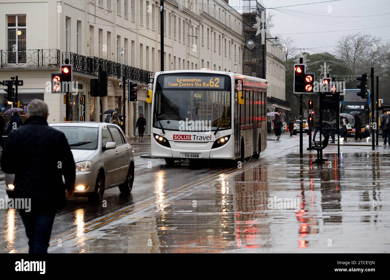 Solus Travel bus service in The Parade during heavy rain, Leamington Spa, Warwickshire, UK Stock Photo