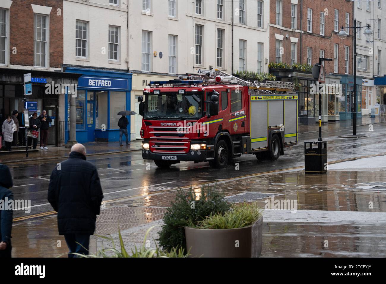 Warwickshire Fire and Rescue fire engine in The Parade in heavy rain