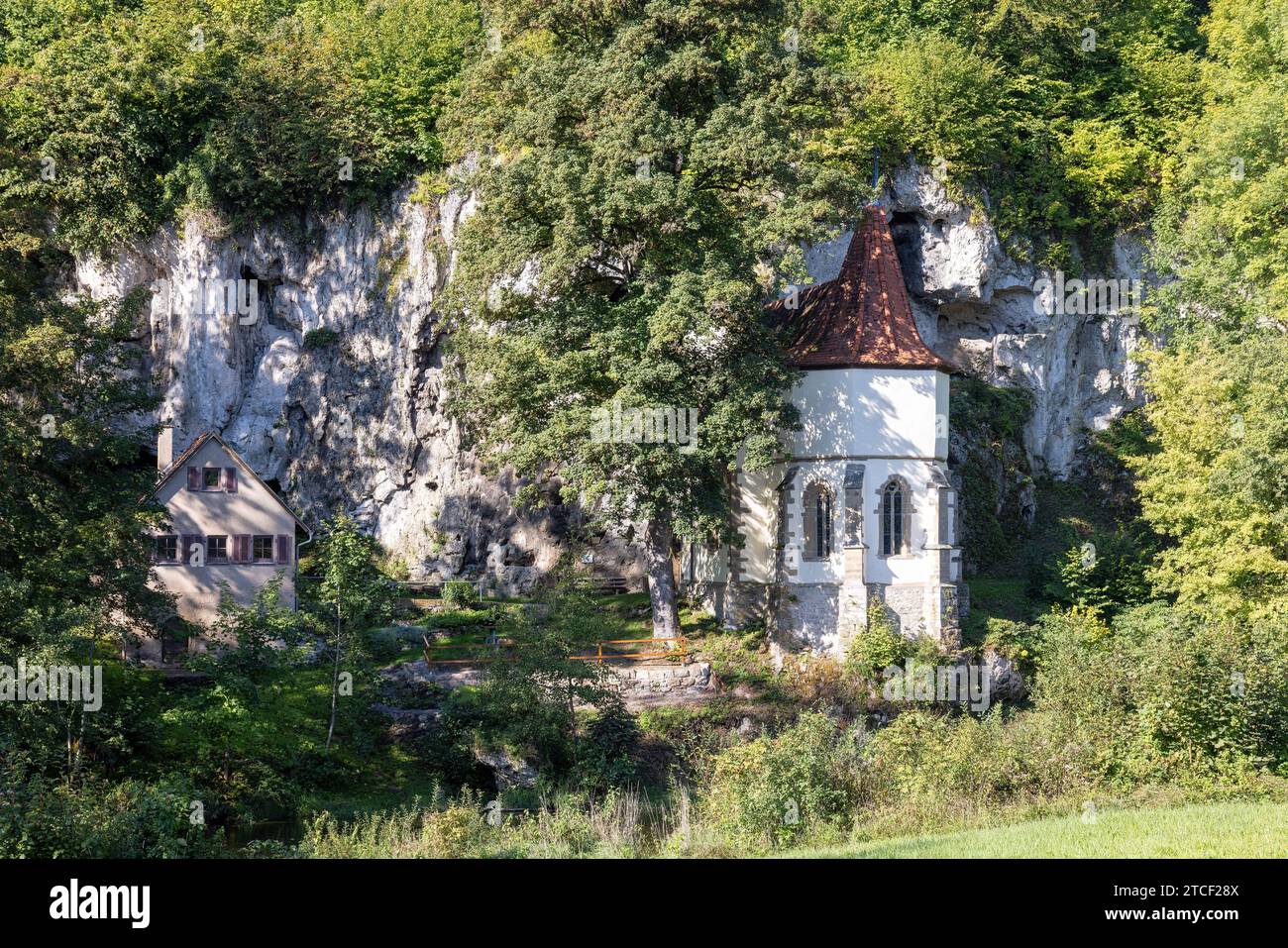 old pilgrimage church of St. Wendel am Stein directly on the mountain with trees in summer Stock Photo