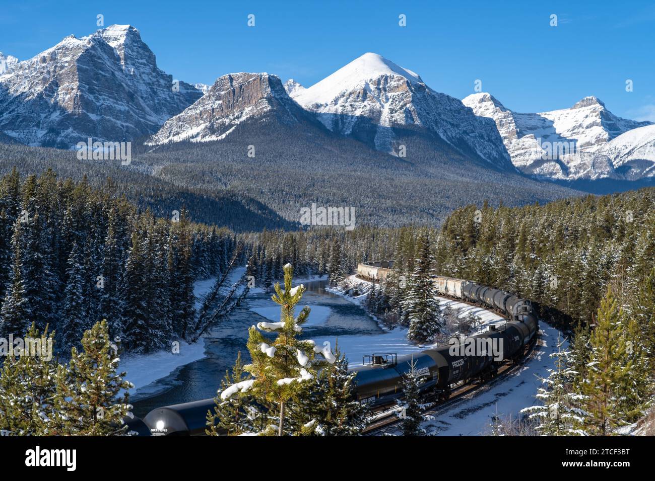 Train going through Morant's Curve in Bow Valley Parkway in the Canadian Rockies in winter Stock Photo