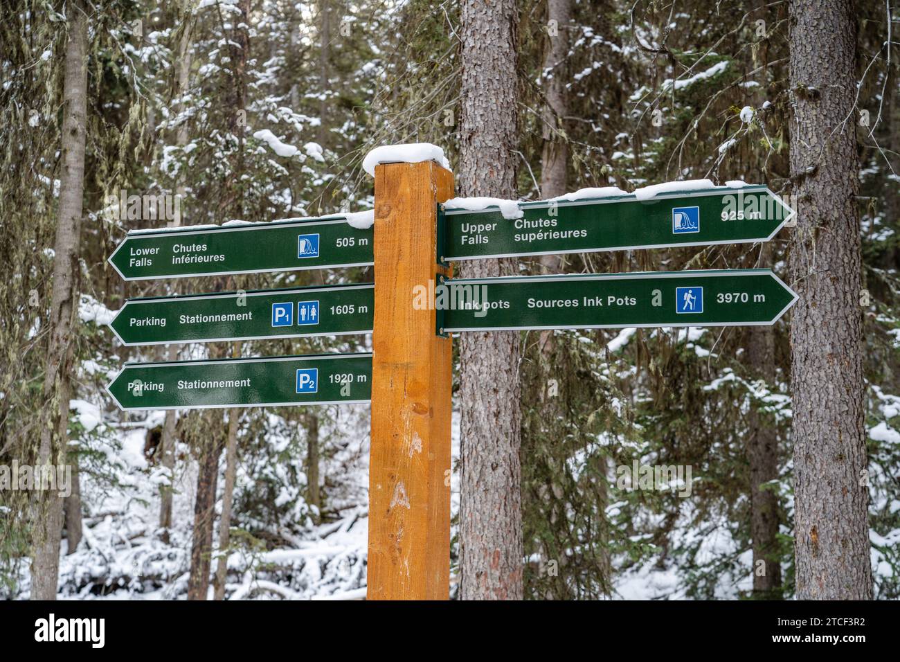 Sign in Johnston Canyon indicating directions to waterfalls and parking