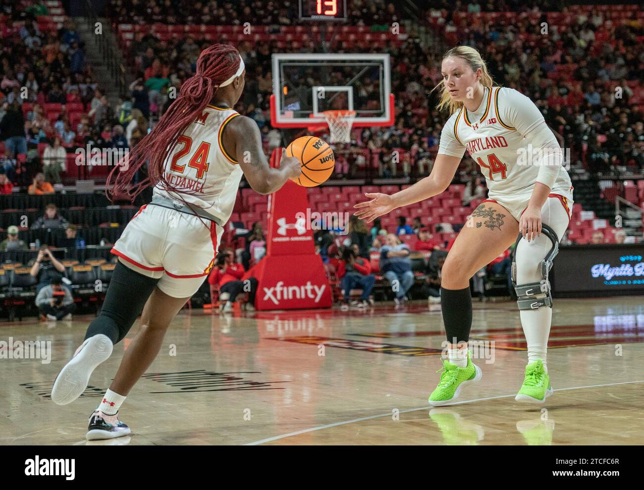 College Park, USA. 12th Dec, 2023. COLLEGE PARK, MD: - DECEMBER 12: Maryland Terrapins guard Bri McDaniel (24) hands off to forward Allie Kubek (14) during a women's college basketball game between the Maryland Terrapins and the Towson Tigers at Xfinity Center, in College Park, Maryland on December 12, 2023. (Photo by Tony Quinn/SipaUSA) Credit: Sipa USA/Alamy Live News Stock Photo