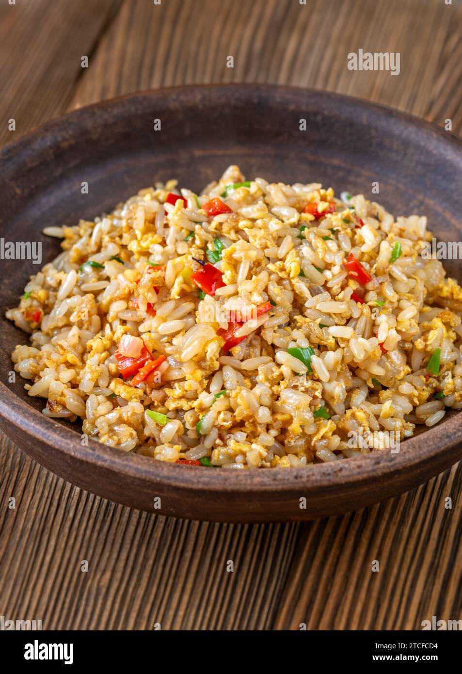 Bowl of traditional egg fried rice on wooden background Stock Photo