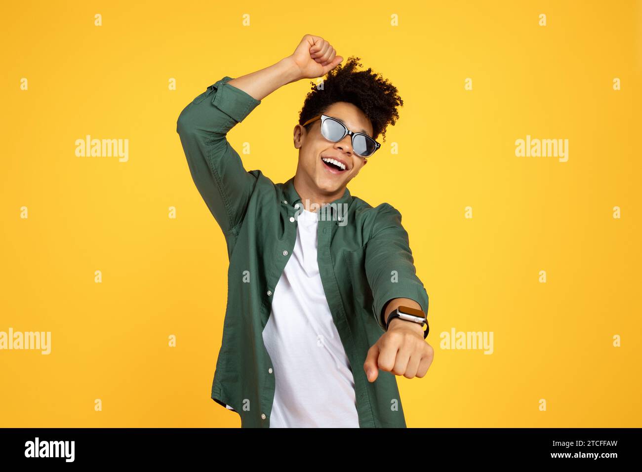 Carefree young black guy wearing sunglasses dancing Stock Photo