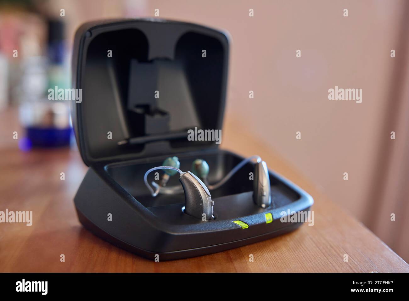 Close Up Of Wireless Hearing Aid Or Device From Charging Case At Home Stock Photo