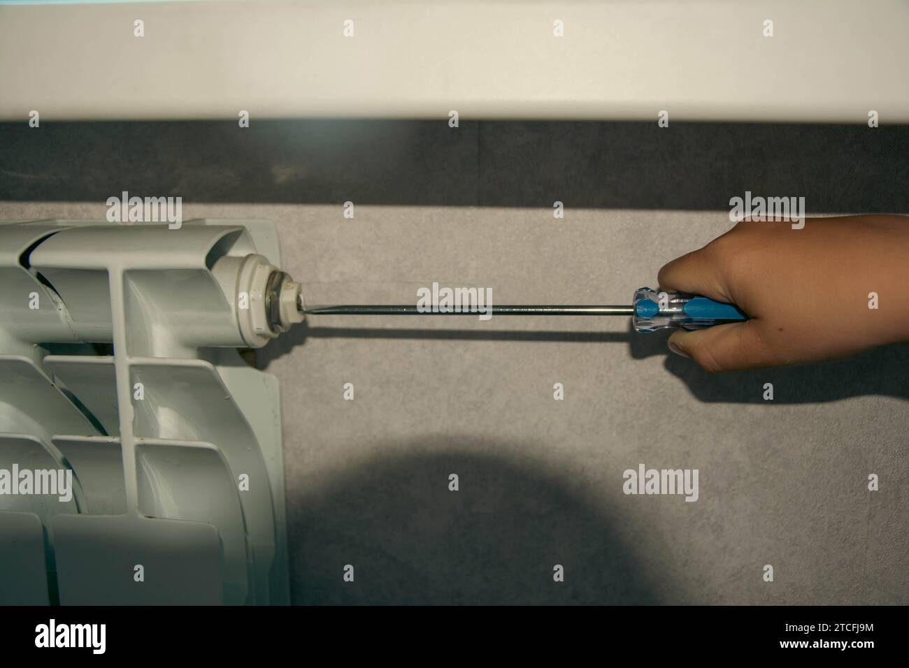 Closeup of a heating system radiator with air being discharged