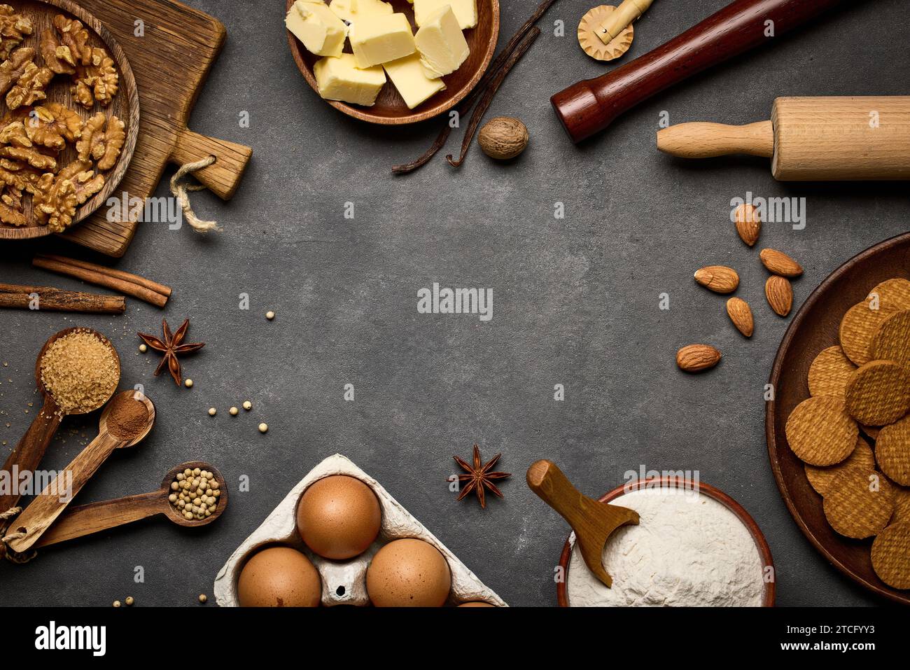 various baking ingredients on dark grey background Stock Photo