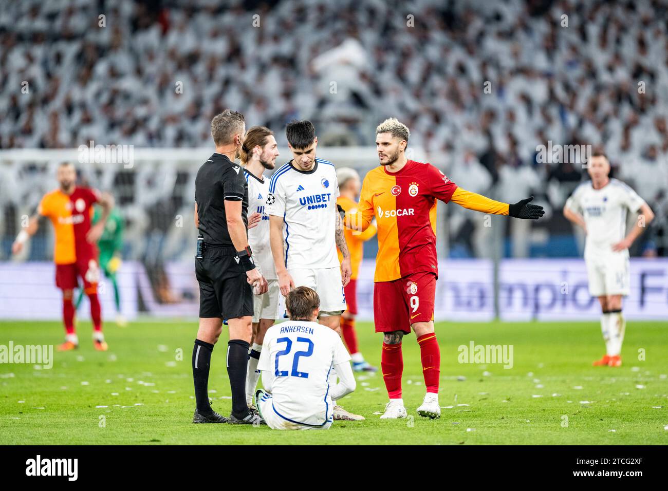 Copenhagen, Denmark. 12th Dec, 2023. Mauro Icardi (9) of Galatasaray, Peter Ankersen (22) of FC Copenhagen and referee seen with referee Daniele Orsato uring the UEFA Champions League match between FC Copenhagen and Galatasaray at Parken in Copenhagen. (Photo Credit: Gonzales Photo/Alamy Live News Stock Photo