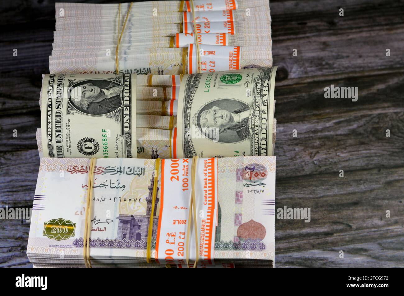 piles-and-stacks-of-egypt-money-thousands-of-pounds-currency-banknotes-bills-of-200-egp-le-egyptian-money-exchange-rate-and-usa-american-dollars-ban-2TCG972.jpg