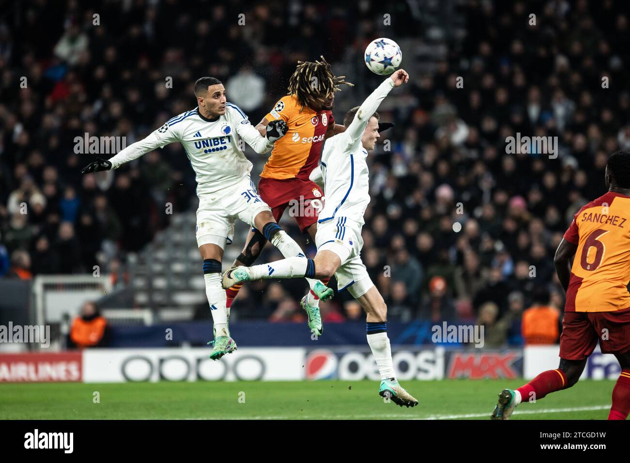 Copenhagen, Denmark. 12th Dec, 2023. Sacha Boey (93) of Galatasaray seen in between Elias Achouri (30) and Viktor Claesson (7) of FC Copenhagen during the UEFA Champions League match between FC Copenhagen and Galatasaray at Parken in Copenhagen. (Photo Credit: Gonzales Photo/Alamy Live News Stock Photo