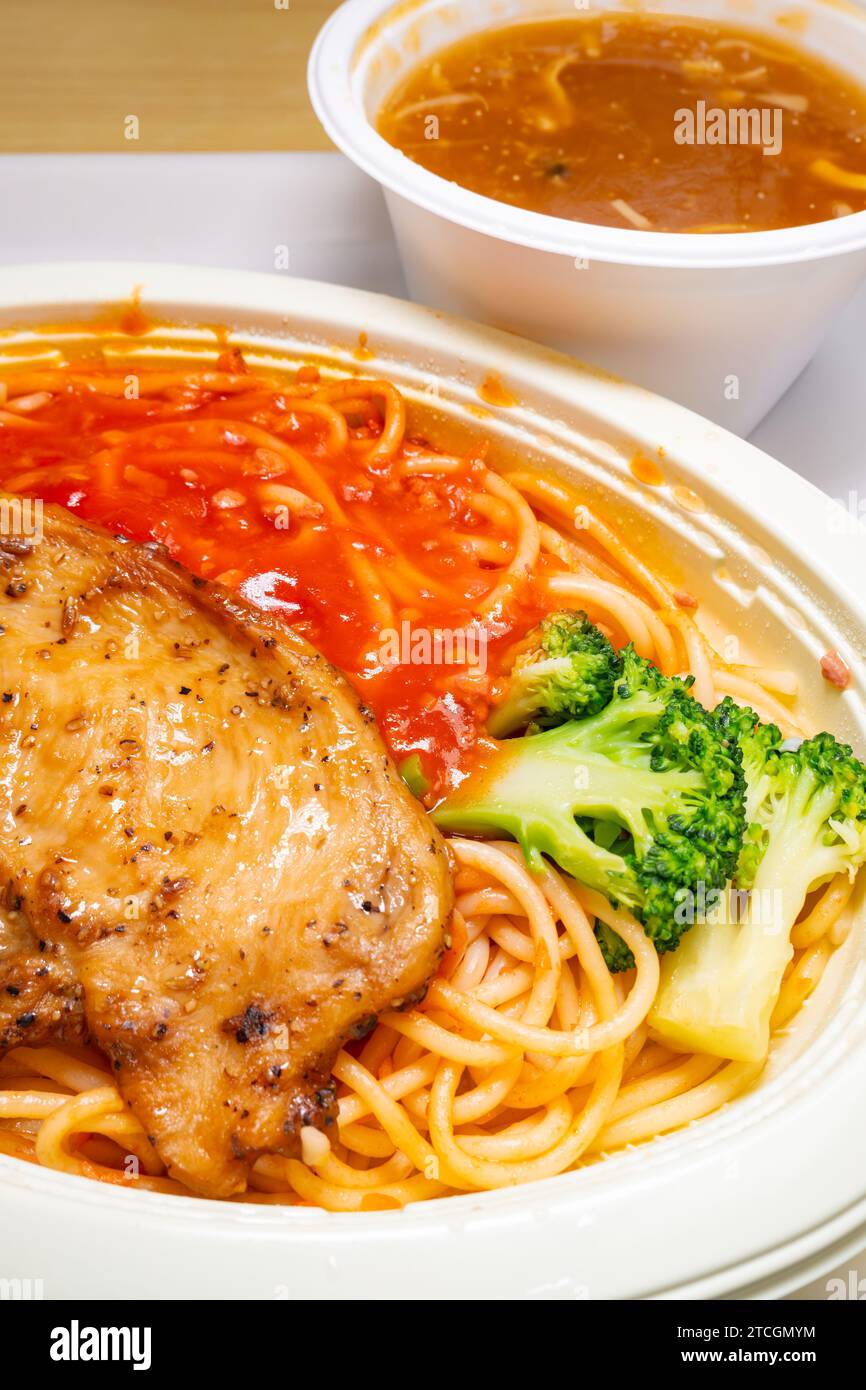 angle view chicken cutlet with tomato and meat sauce pasta and bowl of ...