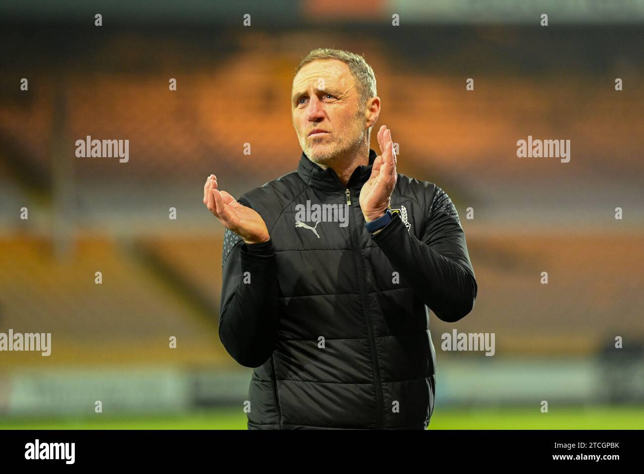 Burslem, UK, 12th December 2023. Port Vale Manager Andy Crosby pictured leaving the field after the FA Cup 2nd Round Replay Penalty loss at home to Stevenage Borough. Credit: TeeGeePix/Alamy Live News Stock Photo