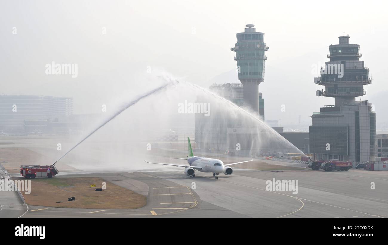 Beijing, China. 13th Dec, 2023. A C919 plane, a China-developed large passenger aircraft, is greeted with a water salute after touching down at Hong Kong International Airport in Hong Kong, south China, Dec. 12, 2023. Credit: Xinhua/Alamy Live News Stock Photo