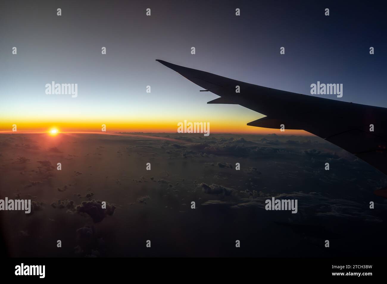 Airplane wing above ocean at sunrise hi-res stock photography and ...