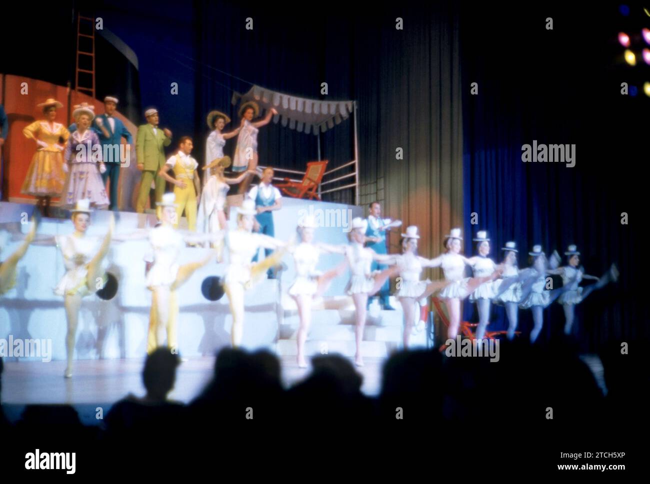 MIAMI, FL - MARCH, 1957: A group of performers sing on stage during an ...