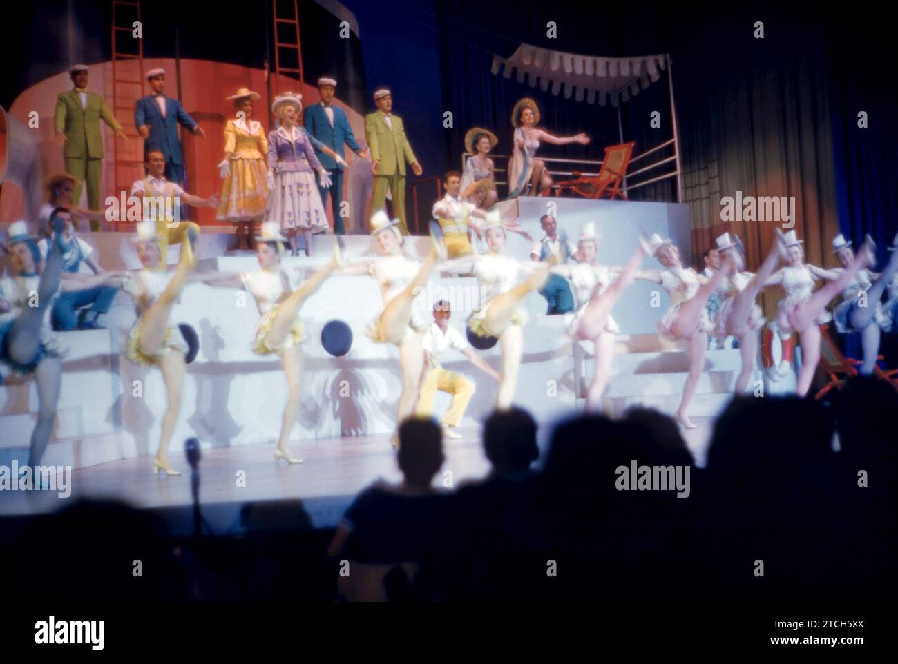 MIAMI, FL - MARCH, 1957: A group of performers sing on stage during an ...