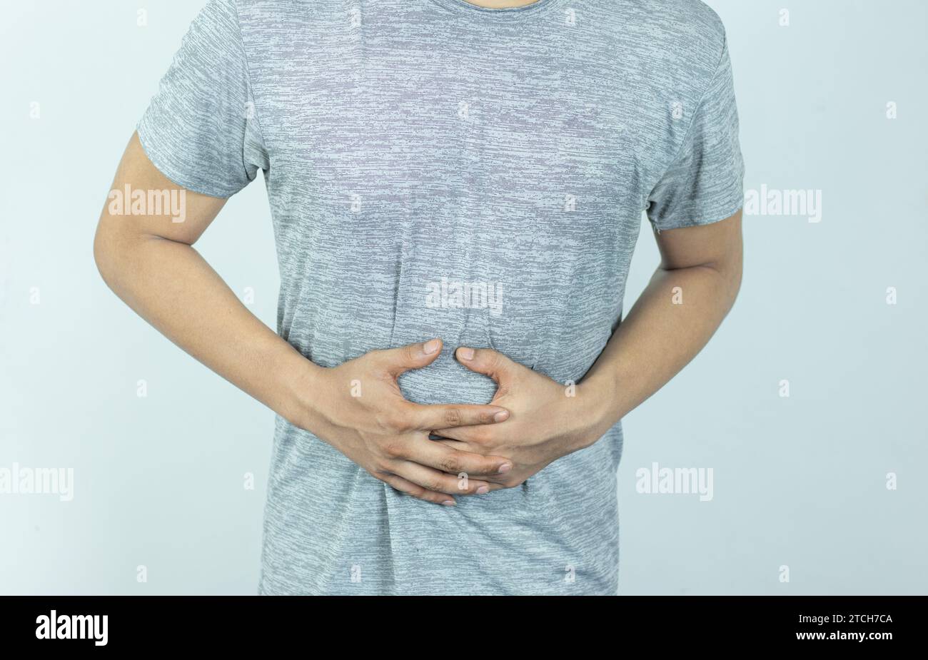 Man suffering with severe stomach pain. Hand of mature guy holding