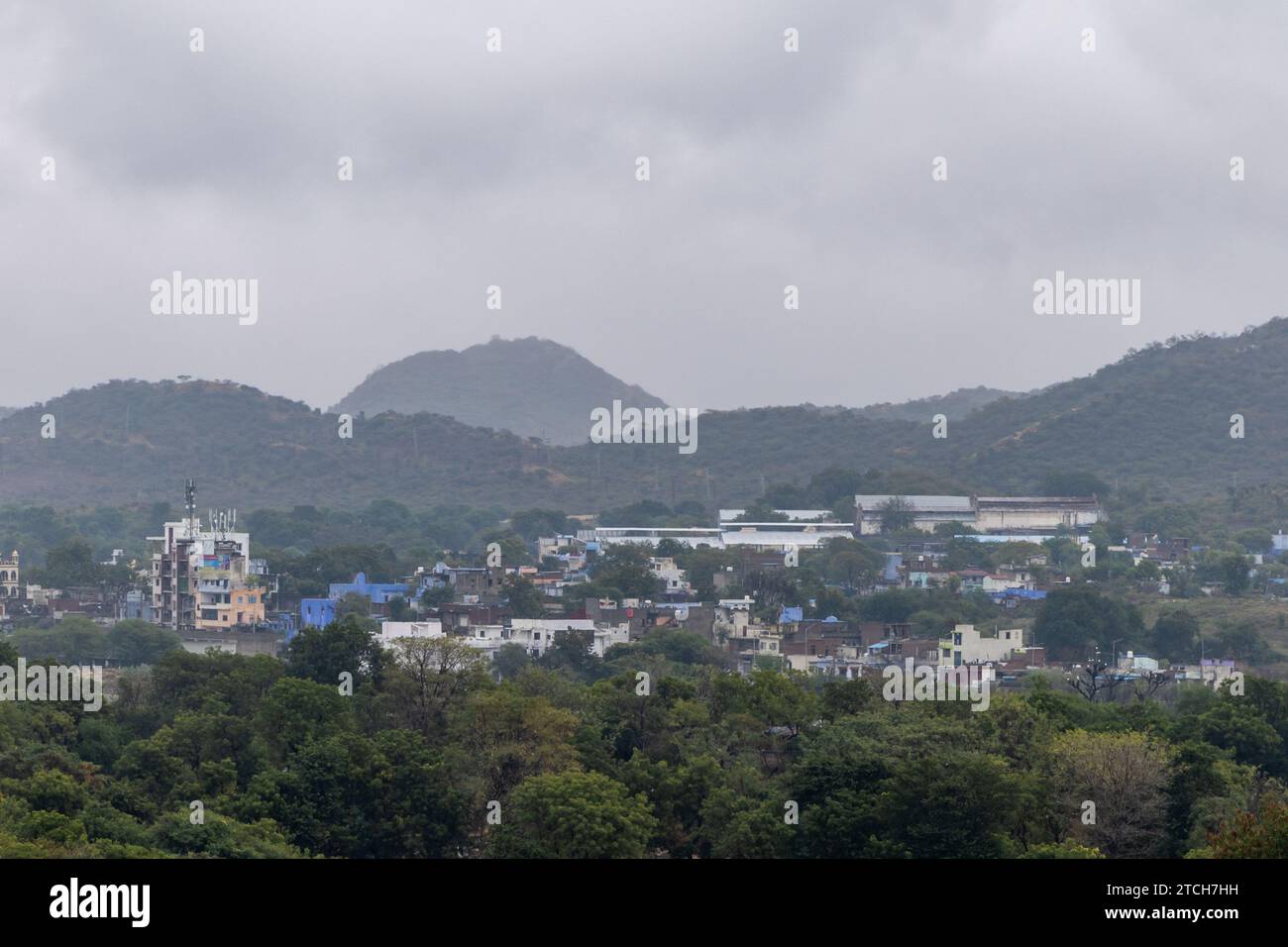 city at the foothill of misty mountain layer at morning from flat angle Stock Photo