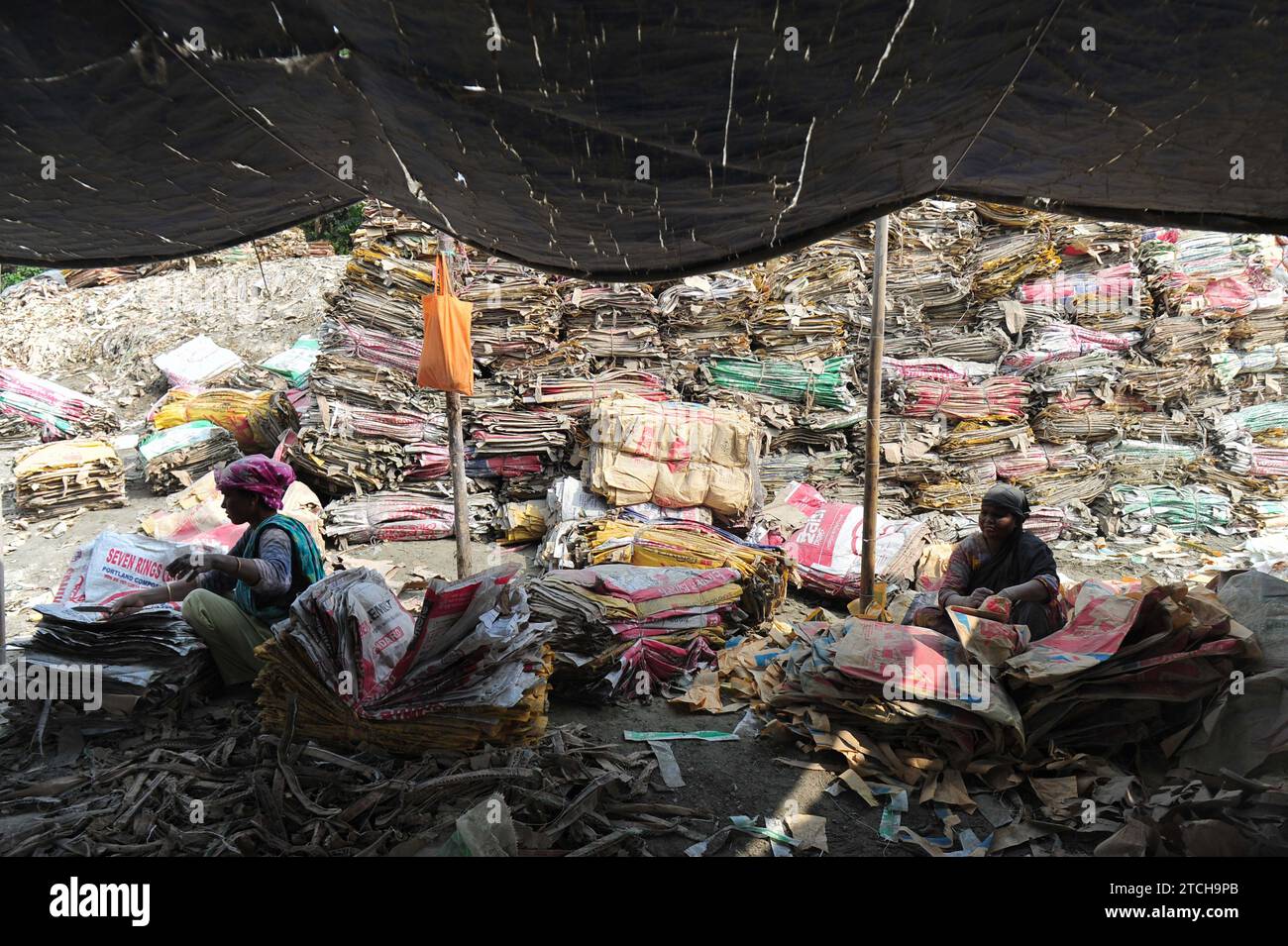 Women are risking their lives to wash cement bags beside the Surma