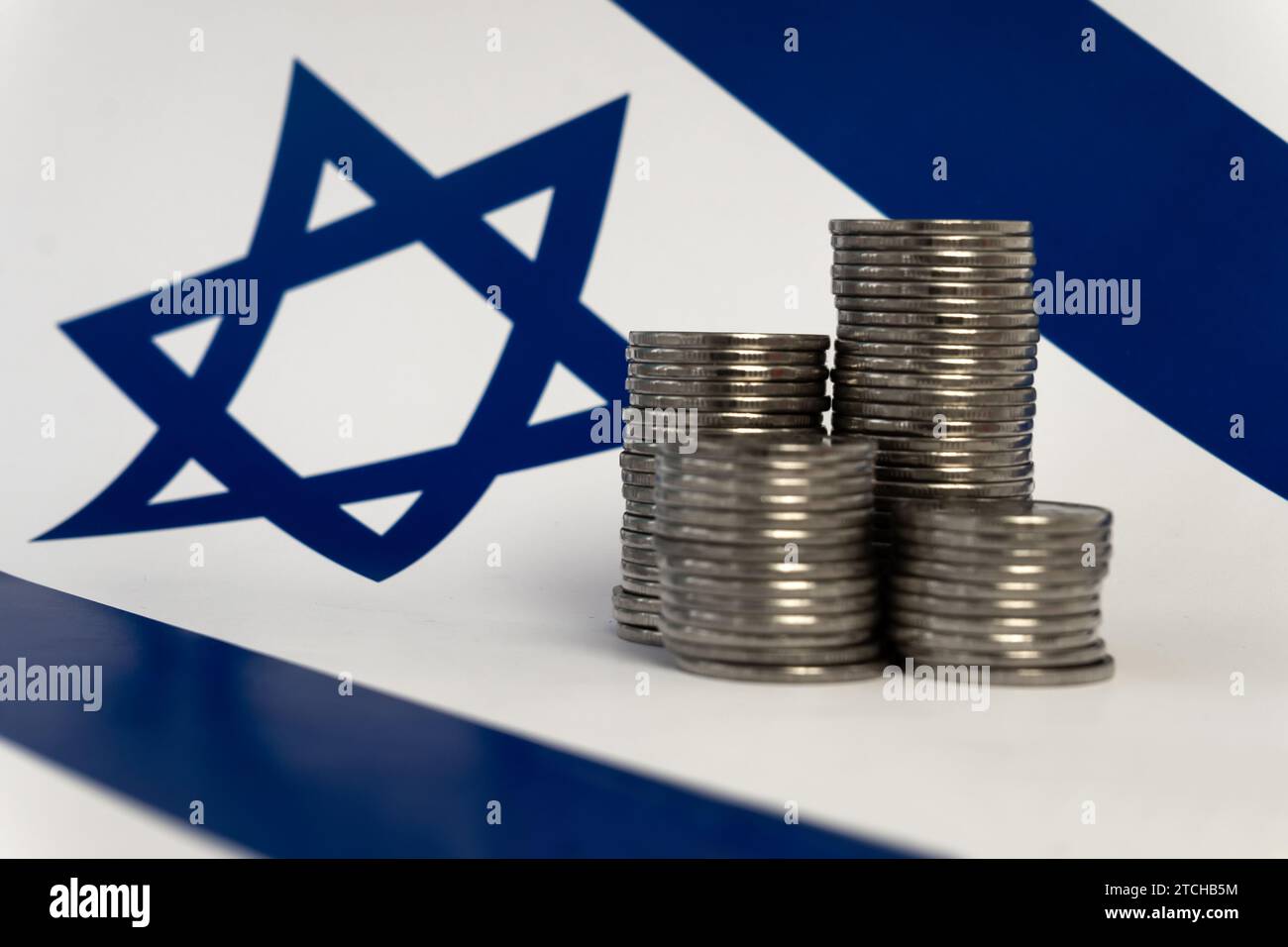 stacks of coins on the background of the Israeli flag Stock Photo