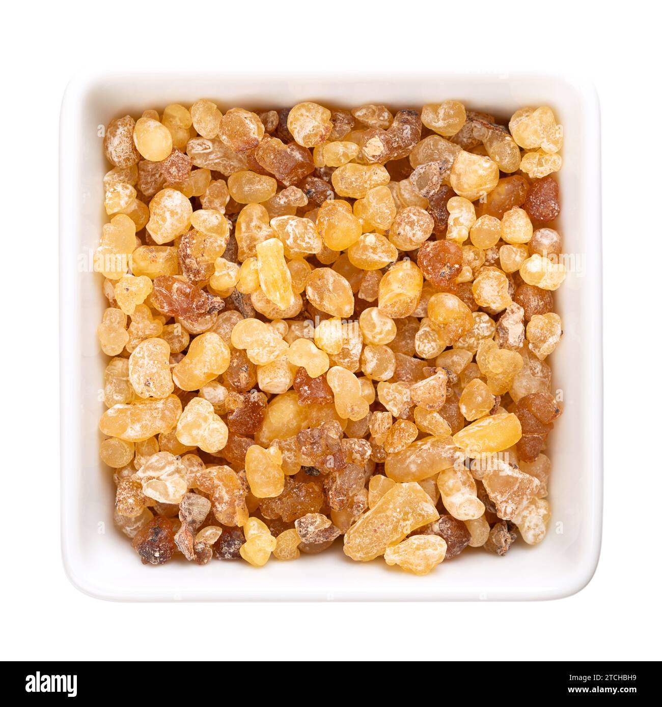 Frankincense resin in a white bowl. Small pieces of hardened aromatic olibanum resin, obtained from trees of the genus Boswellia. Stock Photo