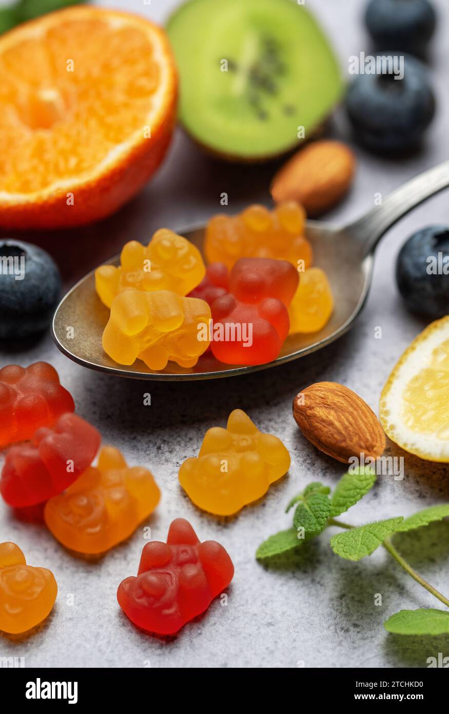 Chewable gummy bears vitamins and supplements and fresh fruits Stock