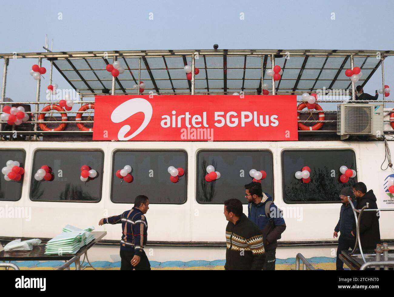 Bharti Airtel Unveils Cutting-Edge 5G Technology December 12,2023, Srinagar Kashmir, India : People walk past logo of Airtel 5G Plus is seen during live 5G plus experience in Srinagar. Airtel announced the launch of its cutting edge 5G services in October, 2022 in 8 cities in India. Today, Airtel s services are live across all states and union territories of India with over 50 million customers as on October 1st, 2023. Srinagar Kashmir India Copyright: xFirdousxNazirxxEyepixxGroupx Stock Photo