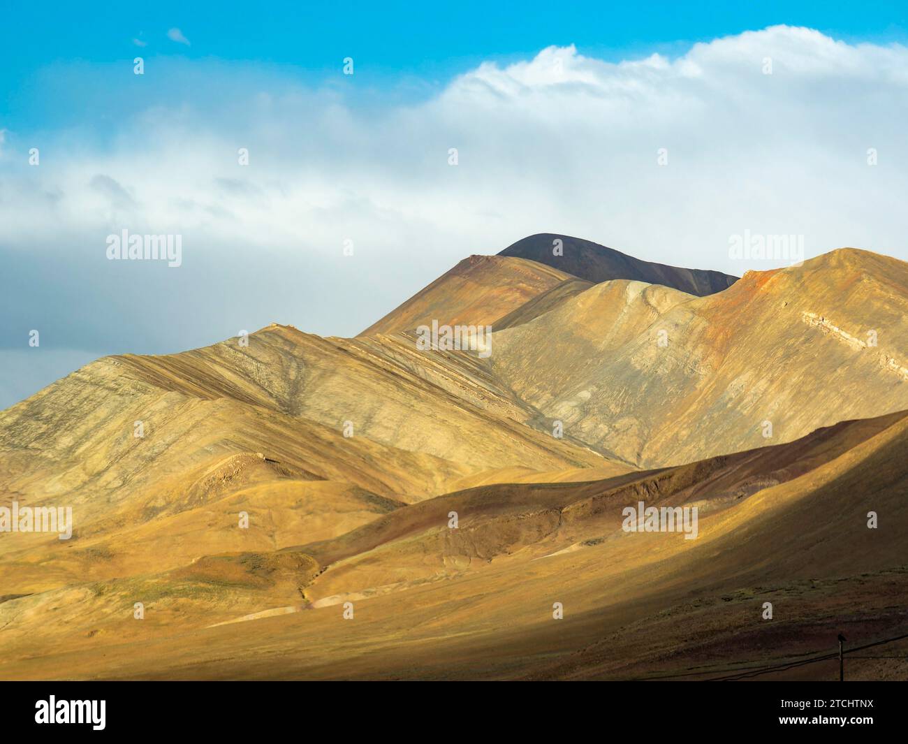 Mountain landscape with yellow mountains in the highlands of Tibet, China Stock Photo