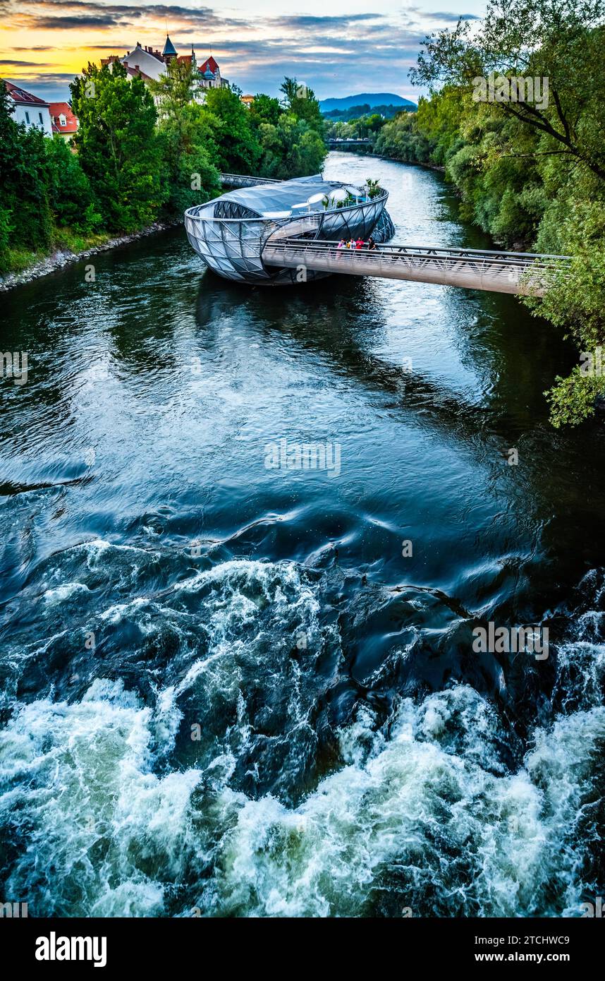 Graz, Austria, 17.08.2019: View at Mur river, Murinsel on bridge, people enjoy beautiful summer. Travel destination Stock Photo
