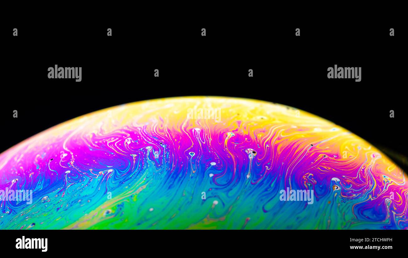 Abstract background made from soap bubble reflecting light. Rainbow soap bubble on a dark background Stock Photo