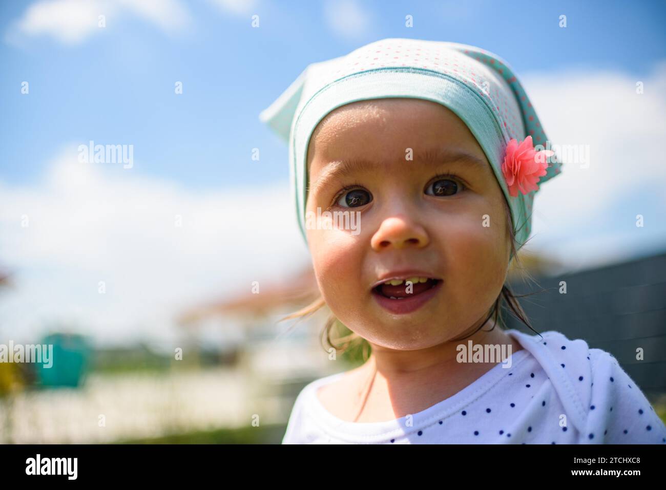 Portrait of very sweet little child with big eyes. 1 year old baby girl. Baby development concept. Copy space Stock Photo