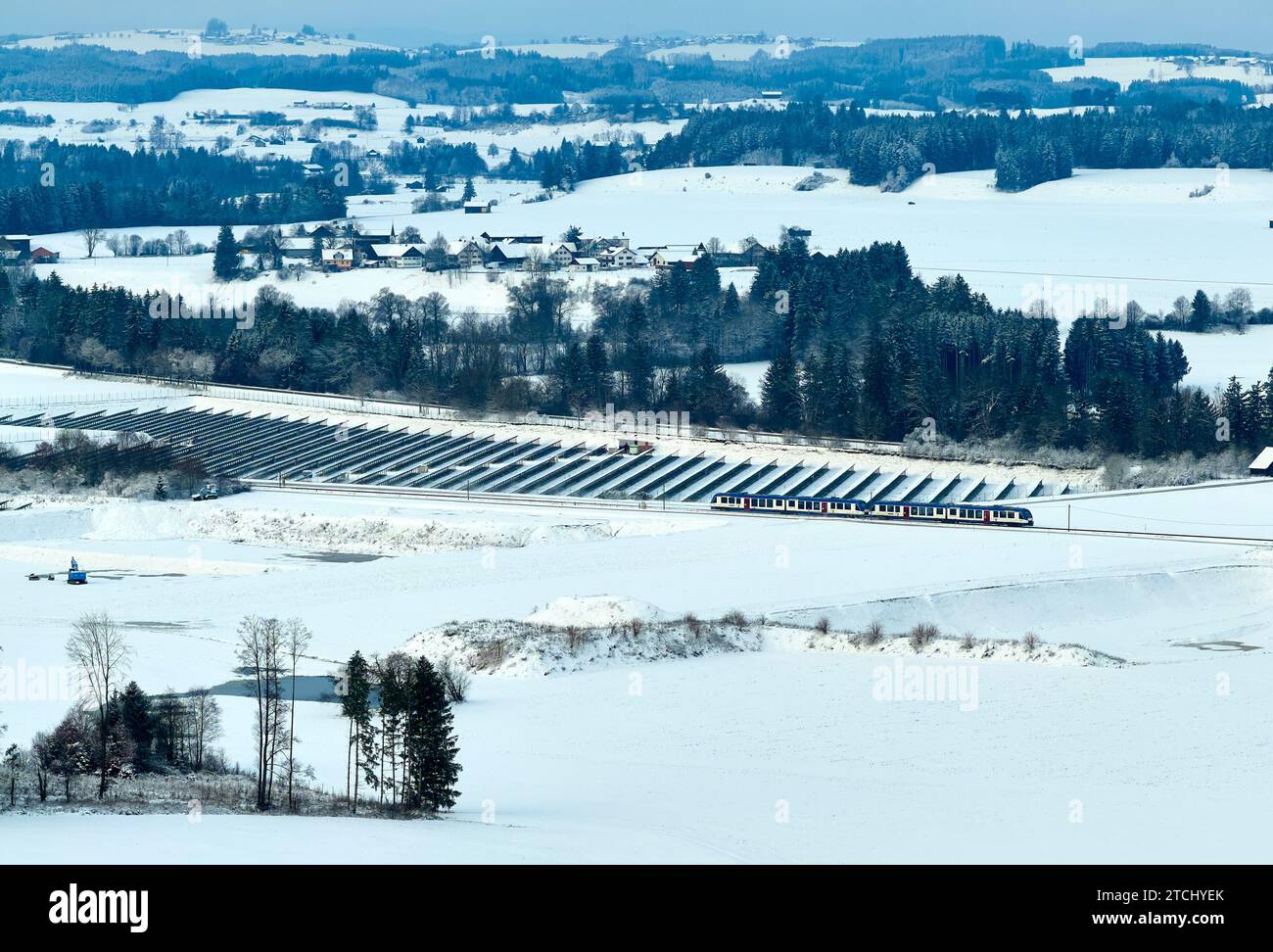 Drone photo of the Bavarian landscape with a BRB regional train passing a photovoltaic field in the morning in Marktoberdorf, Germany, Nov 29, 2023.  © Peter Schatz / Alamy Stock Photos Stock Photo