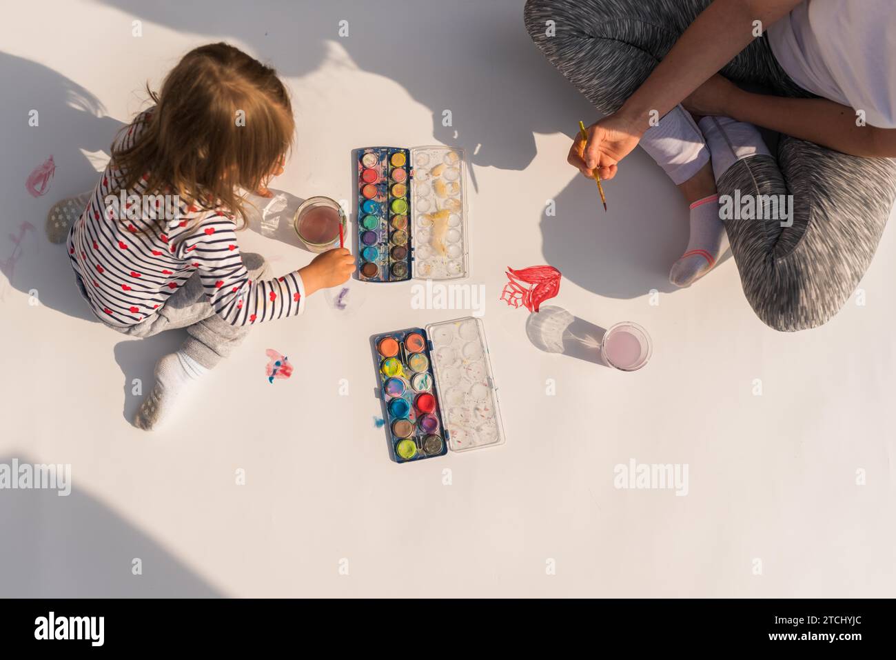 Focused Child With Mother Painting With Poster Paint Outdoors On The Focused child with mother painting with poster paint outdoors on the
