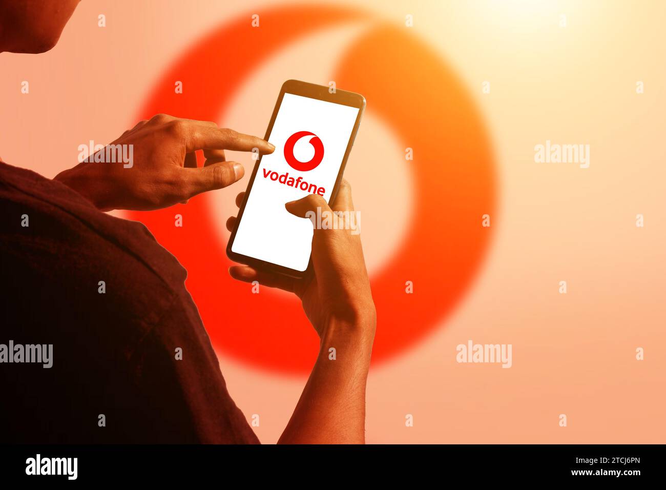 pringsewu, Lampung; December 14, 2023; A man's hand holds an Android cellphone with the logo of the British multinational telecommunications company ' Stock Photo