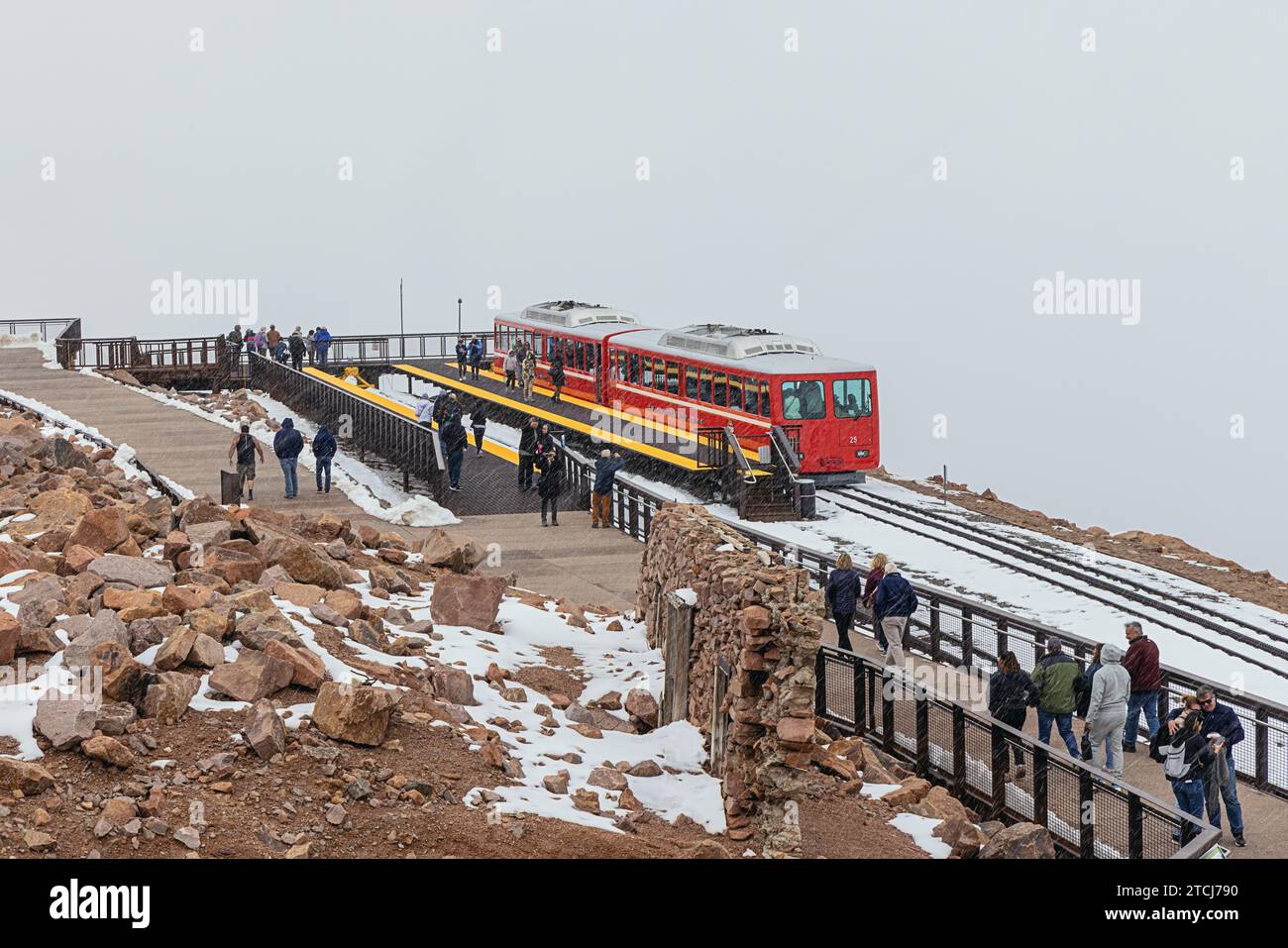 Editorial: PIKES PEAK, COLORADO, UNITED STATES, SEPTEMBER 14, 2023 - Cog railroad waiting for tourists surprised by a snow storm at the summit of Pike Stock Photo