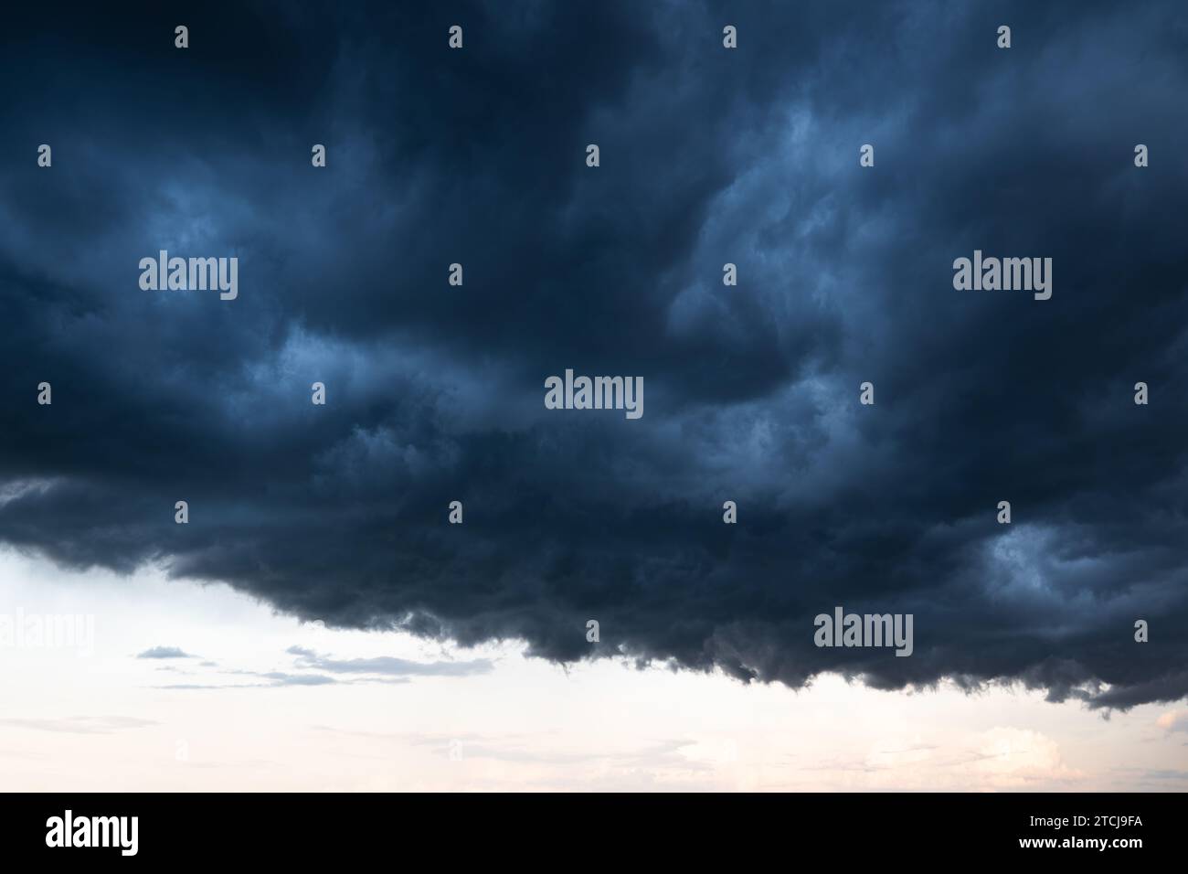 Light in the Dark and Dramatic Storm Clouds background Stock Photo