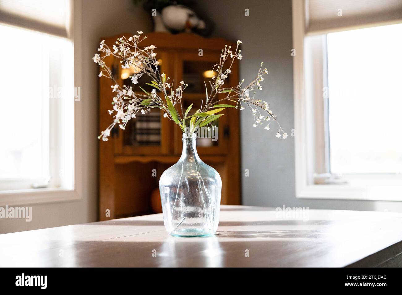 A glass vase filled with assorted wildflowers on the table Stock Photo ...